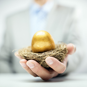 Retirement savings golden nest egg in businessman hand